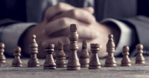 man sitting behind chess board
