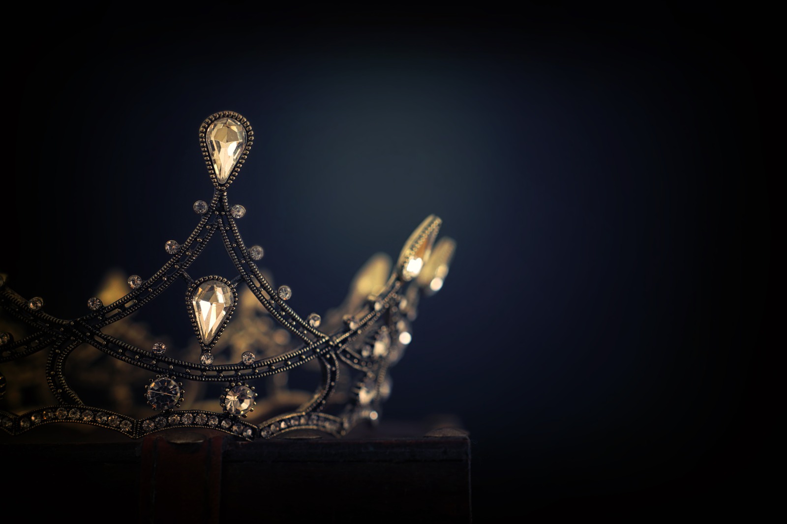 jeweled crown against a dark background