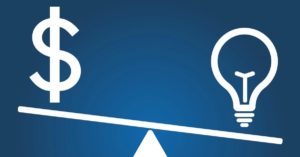 see-saw with a lightbulb down on the right and a dollar sign up on the left