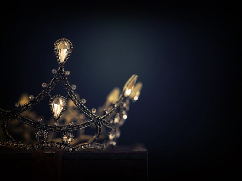 jeweled crown against a dark background